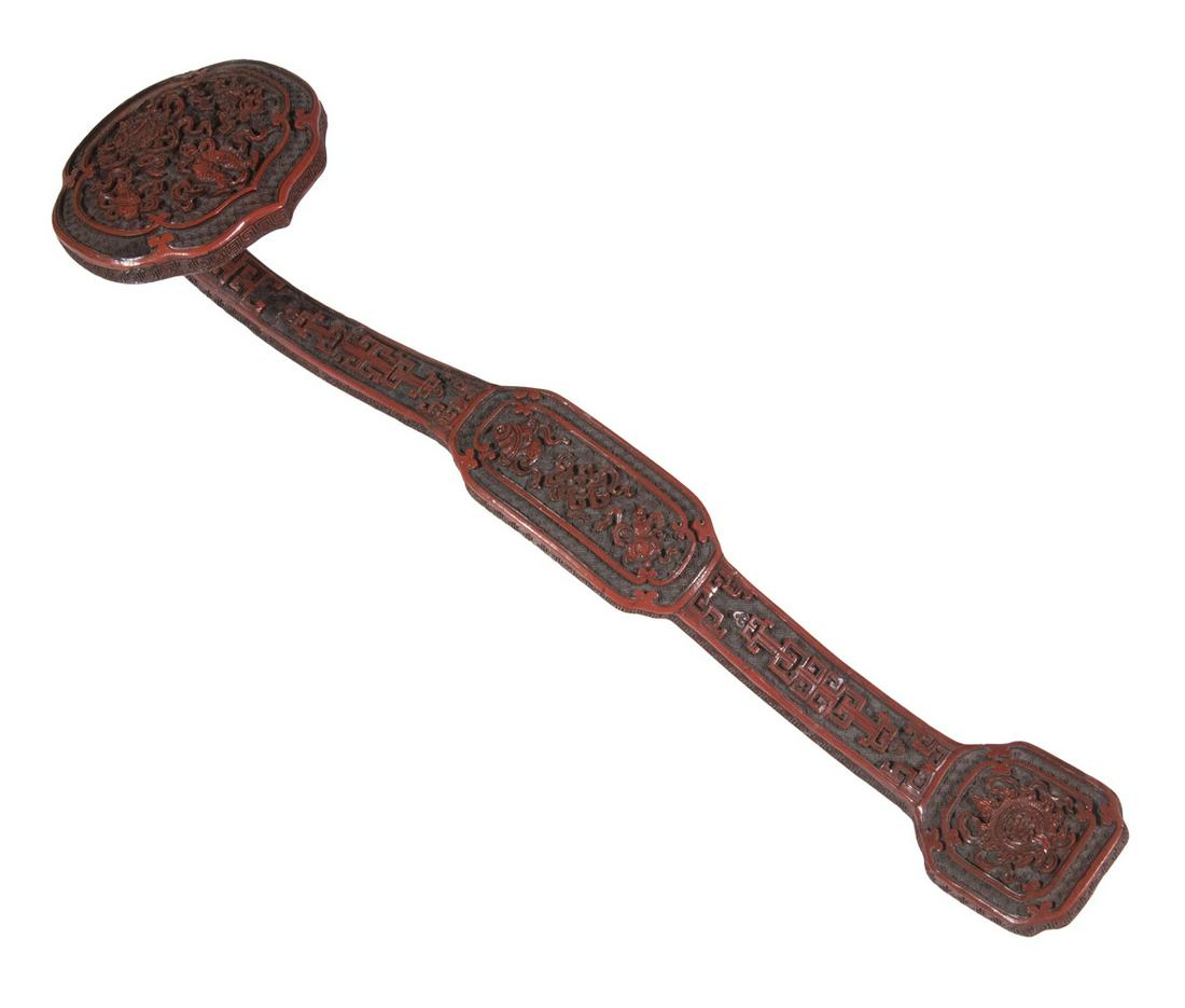 CHINESE CINNABAR LACQUER RUYI SCEPTER, QING DYNASTY: Decorated in very shallow interlocking fortune symbols later known as the swastika, previously adopted as a standard character in Chinese, (pinyin: wan), a fortune symbol that translates as "ten-thous