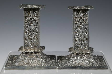 PR ENGLISH STERLING SILVER CANDLESTICKS: Pair of Late Victorian Candle Holders, by William Comyns & Sons, London, 1890, square shape with reticulated putti, floral and vine surface, 4 1/2" high, 3 3/4" sq. base, 13.3 ozt. Good condition.