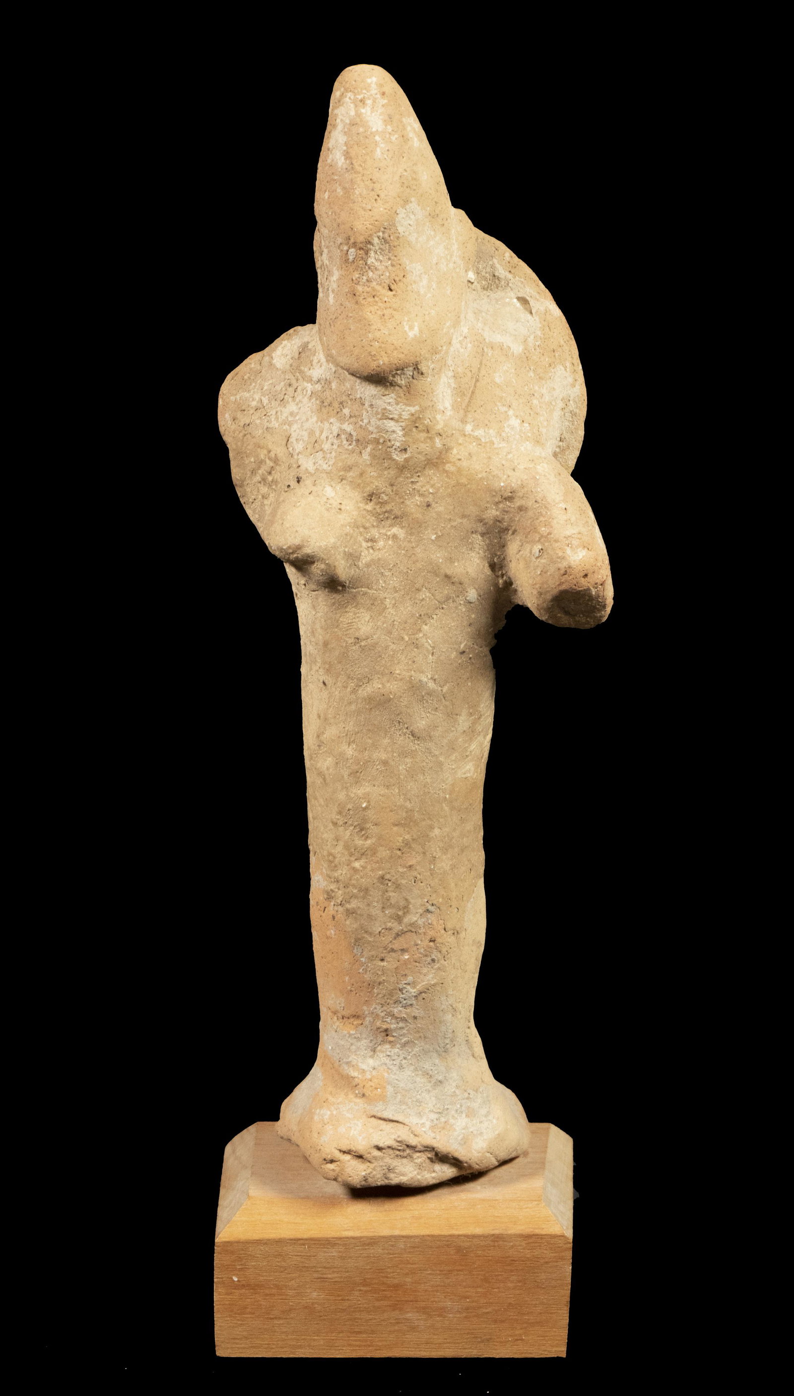 INDUS VALLEY POTTERY FIGURE, CA. 300 B.C.: Standing Figure of a Scythian Warrior, with shield strapped to back, conical helmet, on teak mount, label verso from Royal Athens in New York & Beverly Hills, 6 1/4" figure, 7 1/4" overall. Collection