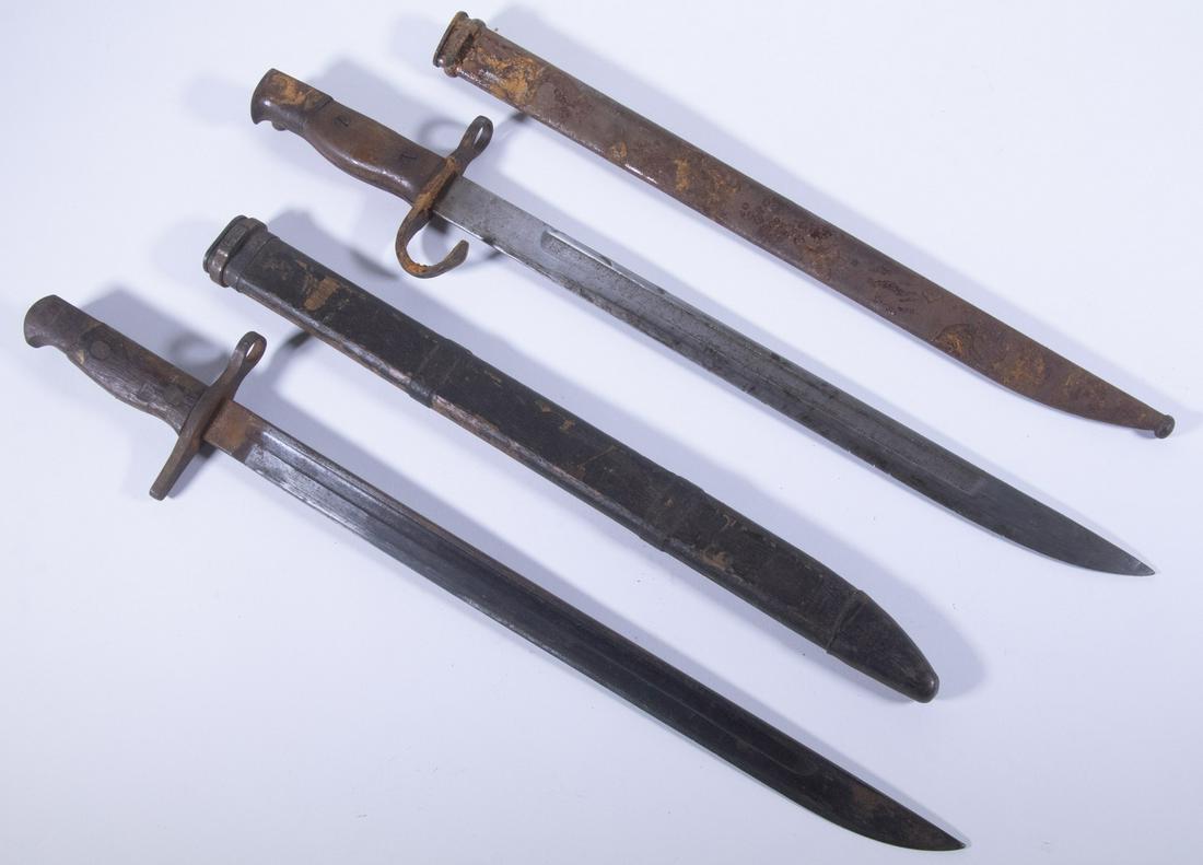 (2) WWII-ERA JAPANESE BAYONETS: A lot of two Japanese bayonets for the Type 99 rifle from different periods of the war. One comes from earlier in the war with the characteristic hook-curved guard and full metal scabbard, the other c