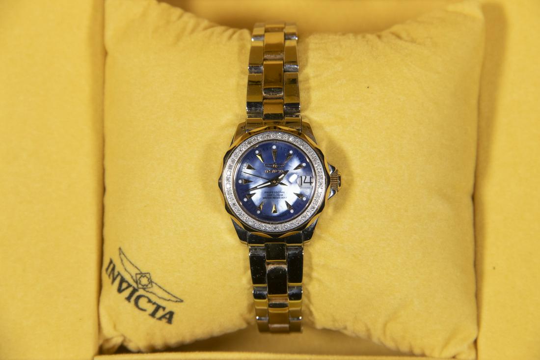 LADIES INVICTA DIAMOND BEZEL WRISTWATCH: Two-Tone Stainless Steel Swiss Movement Diver Watch, #3042, with gold plated and diamond bezel, mother-of-pearl face marked "Professional, 330-ft 150m, Water resistant", date window with magnifier at