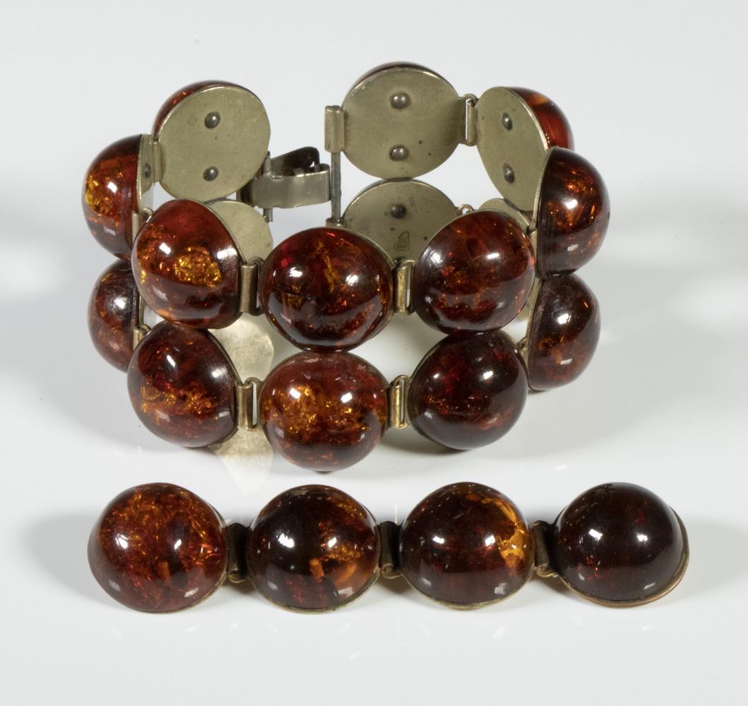 (2 PC) ART DECO BAKELITE JEWELRY SUITE: With Half Spheres of Dark Amber Glitter Bakelite, on white metal, incl: Link bracelet, with sixteen half spheres, 7" long, 1 5/8" wide; and Brooch, with four half spheres, 7/8" x 3 1/2". Minor wear.