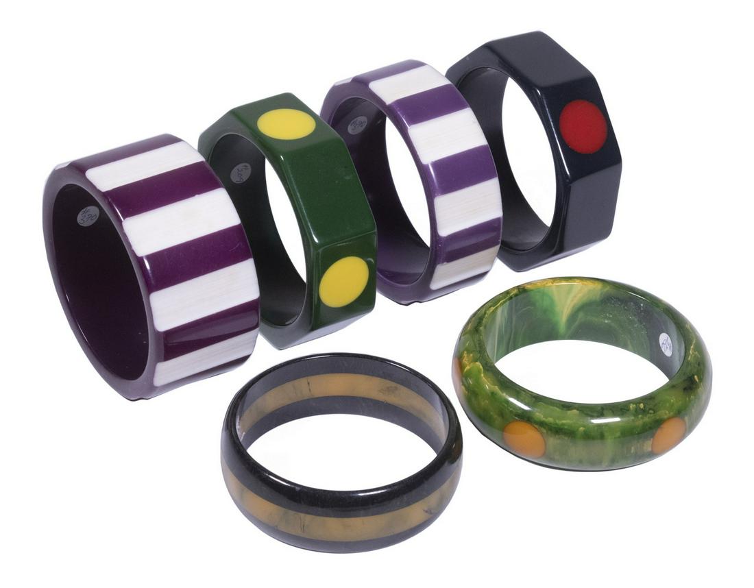 BAKELITE BANGLE BRACELETS: Lot of (6) Multi-color Bracelets, incl: Bracelet by Ron Shultz in marbled green plastic with butterscotch polka dots; (2) with polka dots; (2) in purple with carved white stripes; and Bracelet in marb