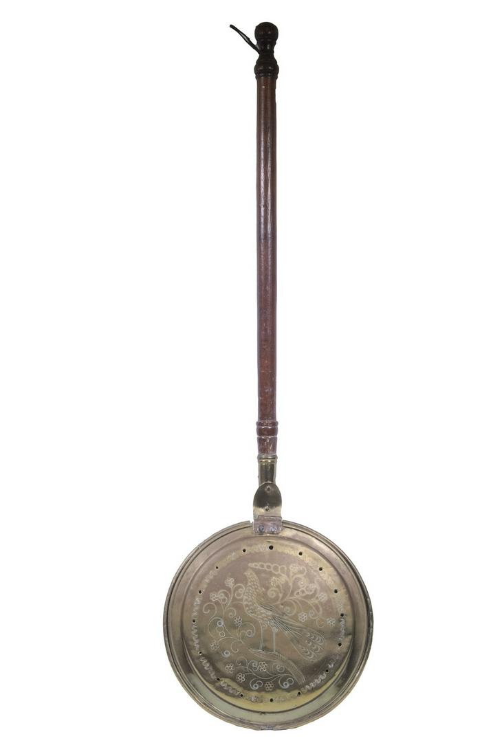 BED WARMER WITH ENGRAVED BIRD: 19th c. Brass Bed Warmer, with turned wooden handle, having a hinged lid with engraved bird amid floral and scrolled motifs, 42 3/4" long. Loss area to lid rim, pan dents, handle chips.