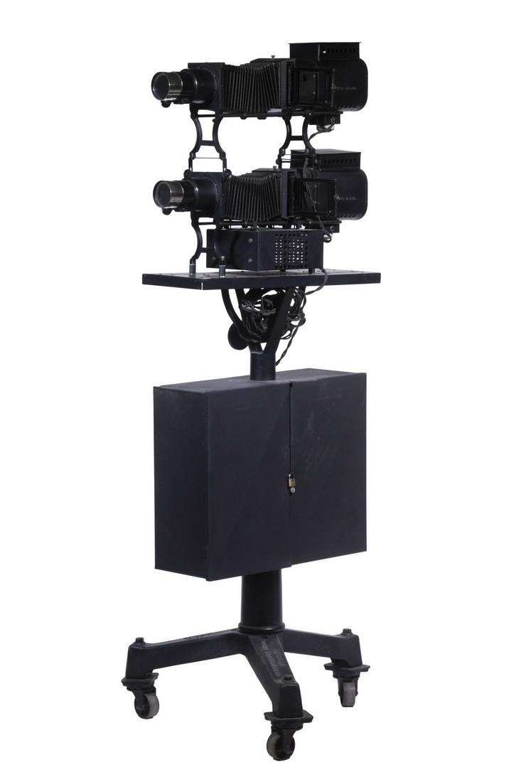 PRESENTATION FLOORSTANDING DOUBLE ELECTRIC PROJECTOR BY BRENKERT, 1918, W/(35) MASONIC COLOR GLASS: Free-standing Lecture Projector with dual projectors and rheostat cross-fader, made by Brenkert Light Projection Co. of Detroit MI. Mounted on a heavy cast iron castered tripod base, black painted sto
