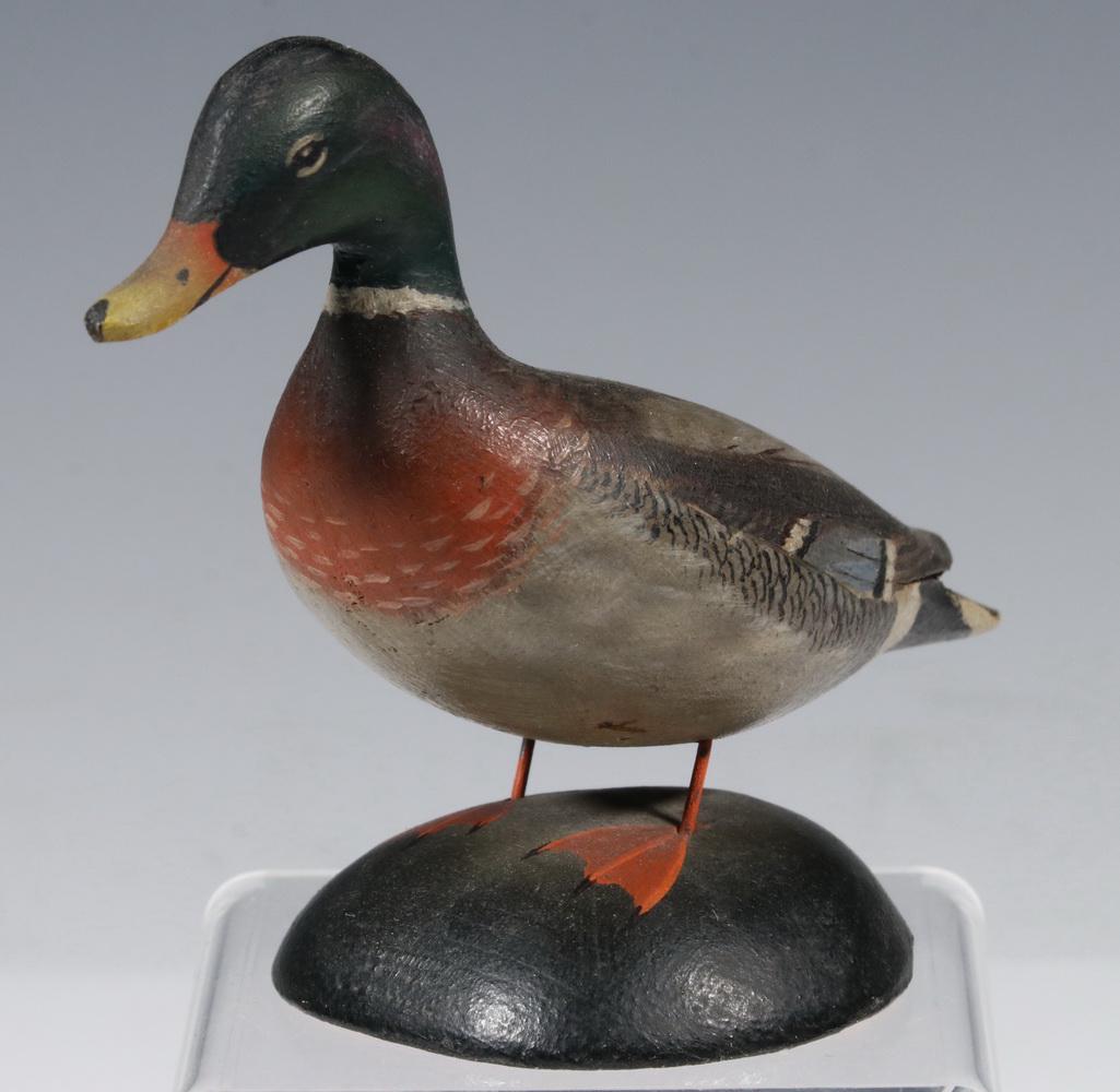 ANTHONY ELMER CROWELL (MA, 1862-1951) MINIATURE DECOY: Mallard Male Miniature Duck Decoy, by master carver Elmer Crowell of East Harwich, MA, with his stamp and label on base, 3 5/8" high, 4 3/4" x 2 1/4". Small chip under tail, otherwise good condition.