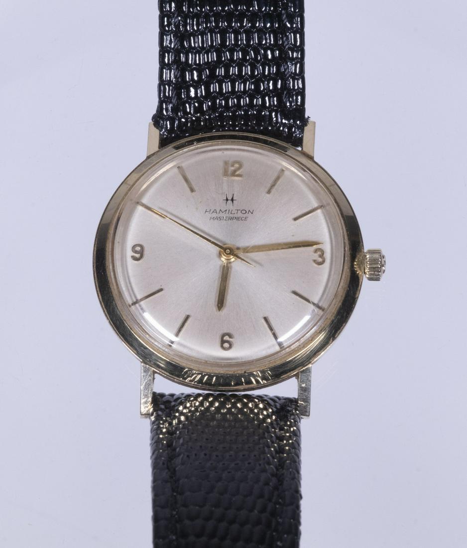 GENT'S HAMILTON 14K GOLD WRISTWATCH: Vintage Hamilton Masterpiece Watch, with 14K yellow gold case, black lizard texture leather band, case back engraved "1969, Paul Schrank, 40 Years Service, New Jersey Bell", 1 1/4" diam. face. Running