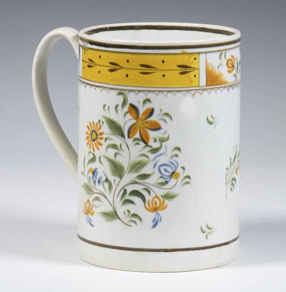 LEEDS SOFT PASTE CHINA MUG: Early 19th c. English Cylindrical Mug, with polychrome floral and foliate decoration, 6 1/8" high, 4 1/2" diam. Side and handle hairlines.