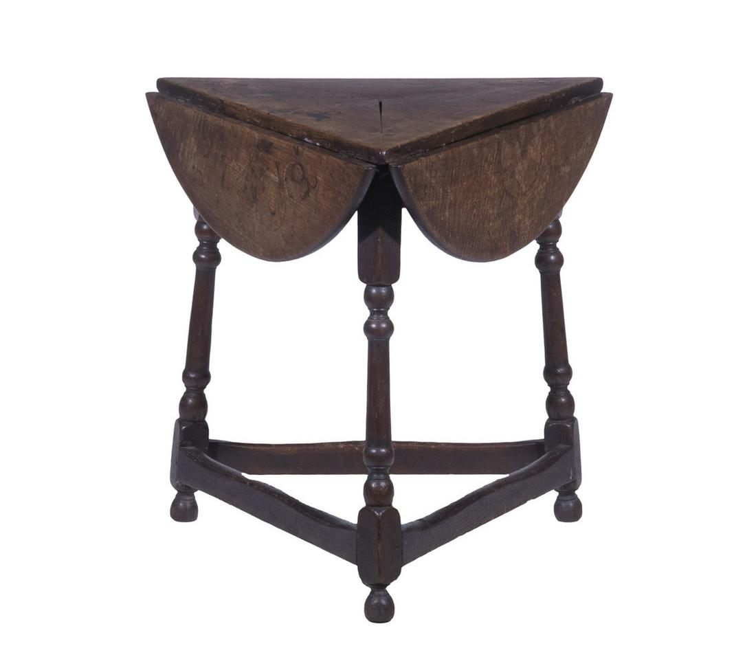 ENGLISH OAK TRICORNER DROP LEAF TABLE: Tripod Low Table, having three drop leaves, set on turned legs with stretcher base, 25" high, 25 1/2" x 25 1/2", 28" diam. (leaves up). Shrinkage, top stains.
