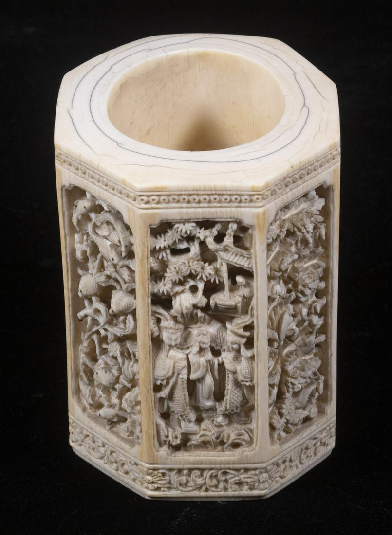 CHINESE IVORY 19TH C. OCTAGONAL BRUSH POT: Decorated with deep undercut relief of alternating panels featuring people with architecture, fish and flowers, 4 3/4" tall, 4" x 3 1/2", very good condition, one bit missing at top of one panel.