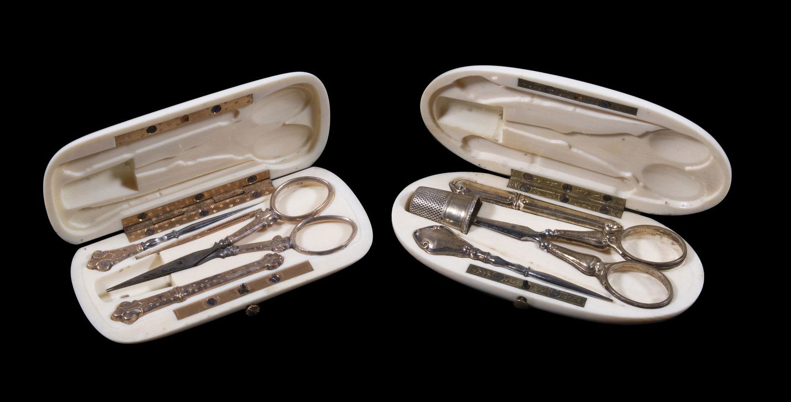 FRENCH NECESSAIRES: Lot of (2) 19th c. Hinged Ivory Cased Sets of Sewing Accessories, both containing gilded silver implements, incl: Oval case with scissors, needle case, thimble, scissors, and awl, 4 1/4" x 2", good co