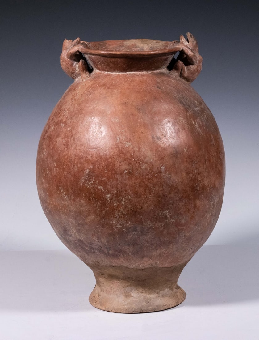 PRE-COLUMBIAN POTTERY: Colima Peru Red Clay Ovoid Footed Jar with two opposing frogs at flared lip, 13 1/2" x 9", reconstructed foot, partial loss to one frog.