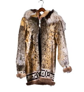 INUIT SEALSKIN PARKA WITH WOLVERINE AND WOLF RUFF: Inuit made. from Alaska, purchased in the 1960's. Lined, with hood, pockets, metal zipper. 20" shoulders, 24" sleeves, 36" chest, 35" long. Very good condition.