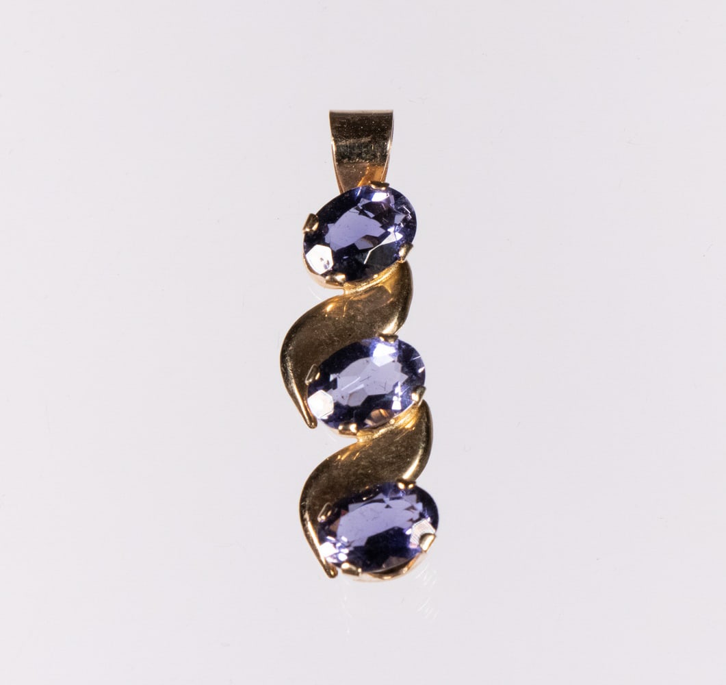 TANZANITE PENDANT: 14K Yellow Gold Mounted Pendant, set with (3) oval faceted tanzanite stones, 1 1/4" long, 1/4" wide, 0.8 dwt tw.
