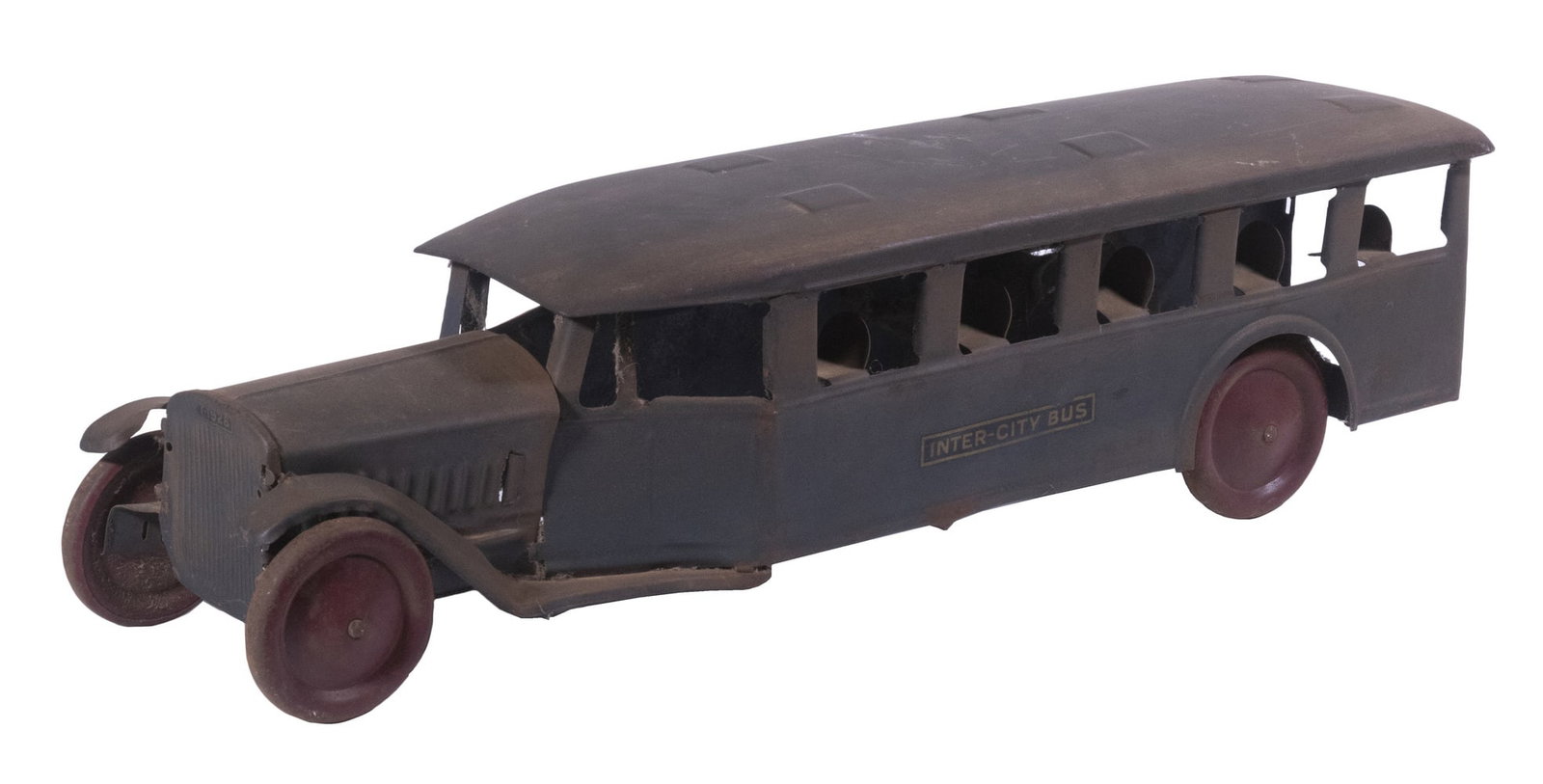 STEELCRAFT TOY INTERCITY BUS: 1920s Era Pressed Steel Toy Bus, with traces of original green color, red wheels, front decal that reads "T-1928", 6 1/2" high, 23 1/4" x 5 1/4". Paint losses, surface rust, missing back panel.