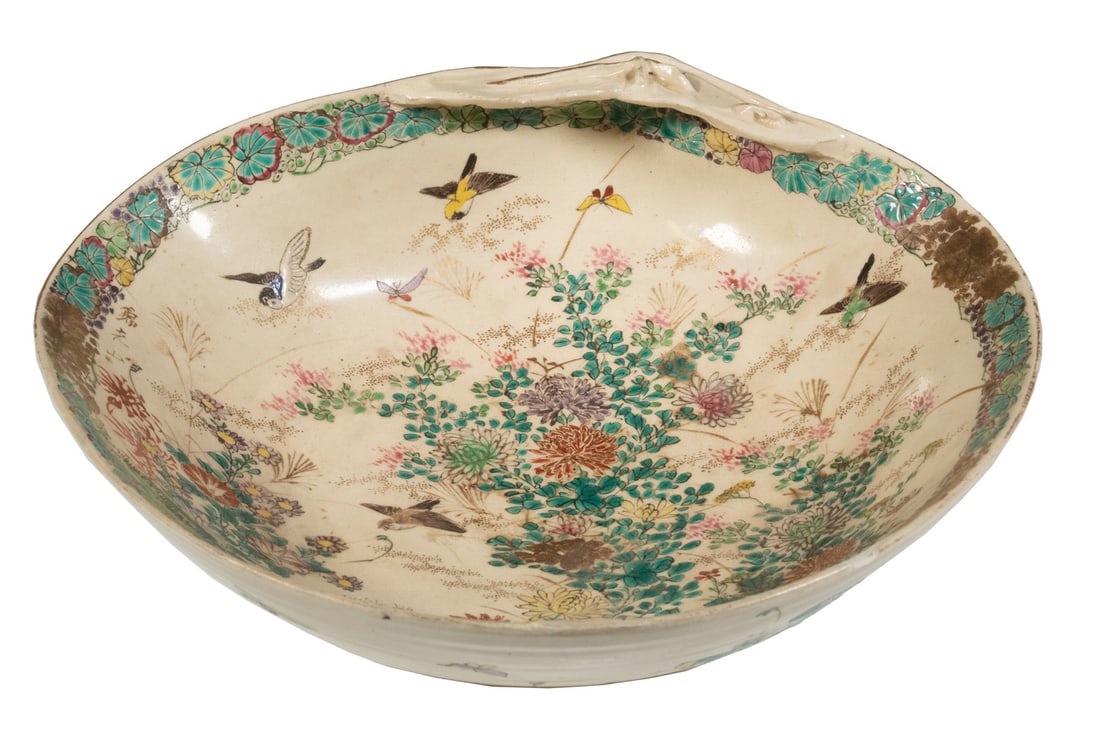 19TH C. SATSUMA BOWL: Kinkozan Clamshell form, with bird and blossoming bush decoration, footed, faintly signed under glaze. 10" wide. Chipped rim.
