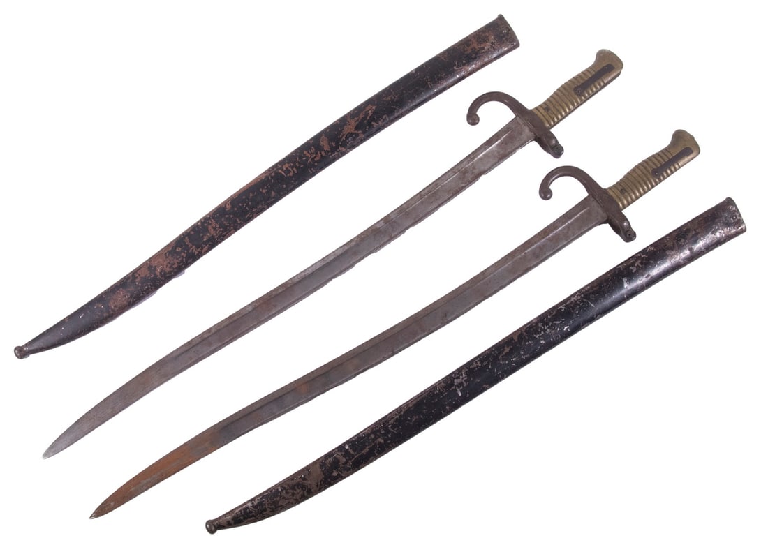 (2) 19TH C. FRENCH BAYONETS WITH METAL SCABBARDS: French Model 1842 Yataghan Sword Bayonets, with multipled proof and unit stamps, maker's name illegible, one is dated June 1868. One scabbard in green paint, the other black. 28" long overall.