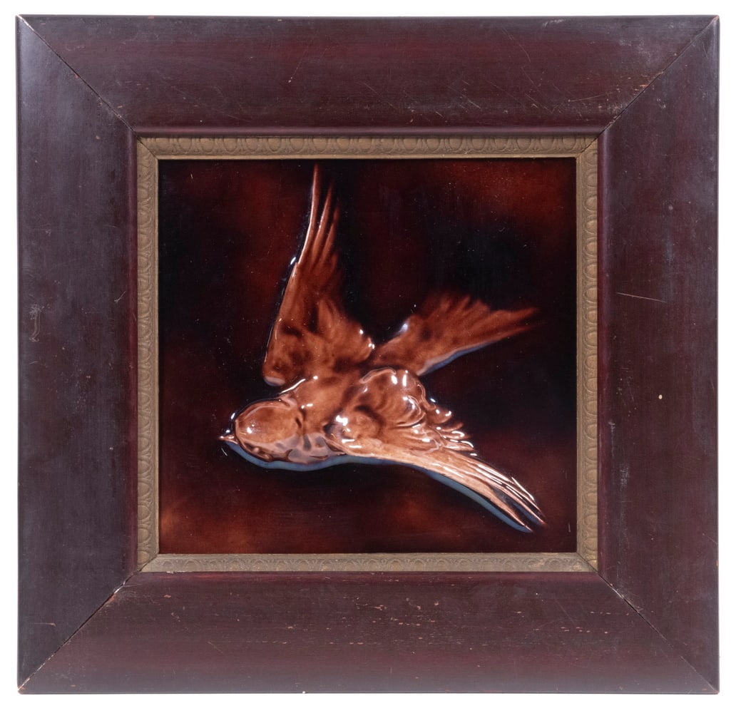 FRAMED CERAMIC TILE BY J. & J.G. LOW ART TILE WORKS: Late 19th c. Relief Molded Tile, by J. & J.G. Tile Works (1877-1902), depicting a swallow bird in flight, with glossy brown glaze, double maker's stamp on base, 8" x 8"; in a mahogany frame with gold