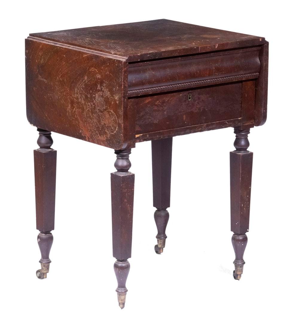 EMPIRE MAHOGANY SIDE TABLE: Ca. 1830 Dropleaf Stand, with bookmatched figured veneer top, two drawers, set on turned and tapered legs with casters, 29" high, 21" x 18", 10" leaves. Veneer and finish losses. From the Percival Bax