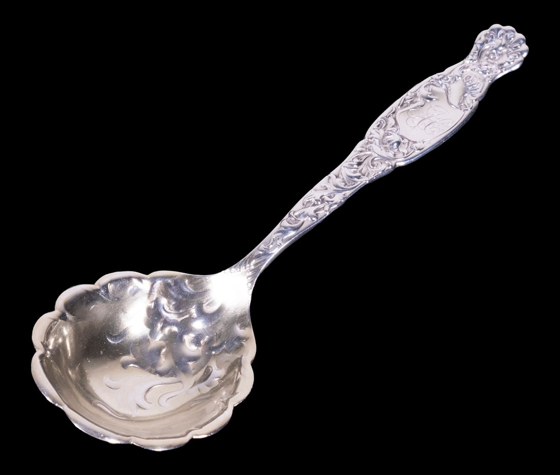 WHITING "HERALDIC" PATTERN BERRY SPOON: Sterling Silver Serving Utensil by Whiting Manufacturing (1866-1926), with repousse decorated bowl and scalloped rim, monogrammed, 7 1/4" long, 2.04 ozt.