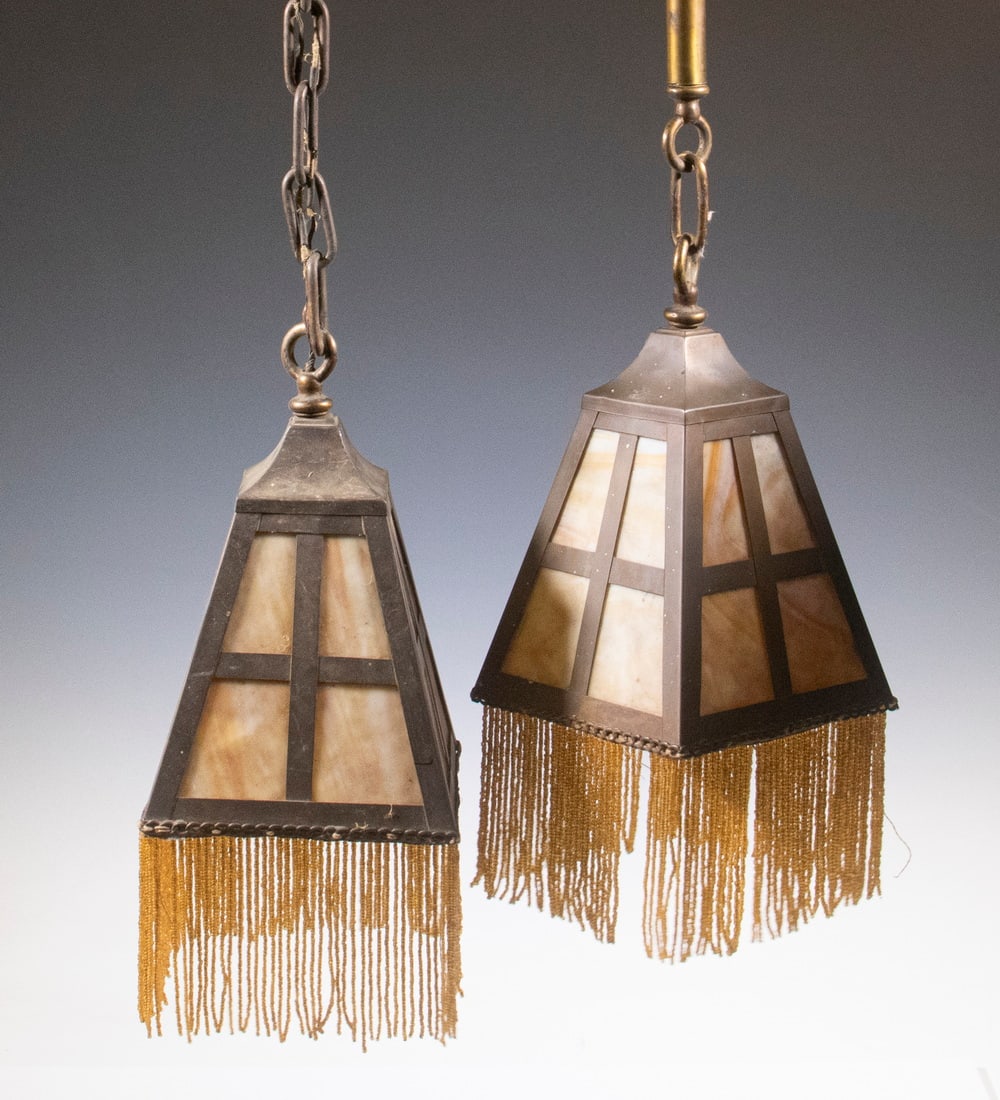 PR ARTS & CRAFTS SLAG GLASS HANGING LIGHTS: Pair of Early 20th c. Bronze Ceiling Fixtures, with caramel slag glass panels, each with beaded fringe attached to base, single socket fixtures with ceiling caps, one with chain, fixture only: 9 1/2" 