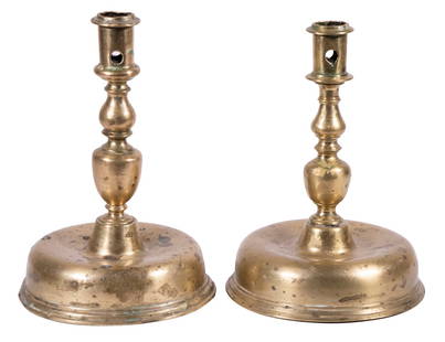 PR OF 17TH C. SPANISH BRASS CANDLESTICKS: Cast Brass with large domed bases having molded edge, two graduated urn turned columns, molded cylinder cup with cleaning port, no drip guards, 9 1/4" x 6 1/4" diam. One screw joint has been soldered