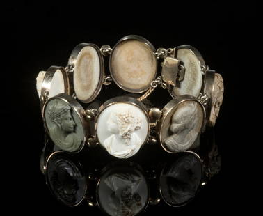 VICTORIAN LAVA STONE CAMEO BRACELET: Ca.1860s 10K Yellow Gold Mounted Bracelet, with (8) oval carved lava stone cameo plaques depicting Classical figure bust profile portraits, with safety chain, 7/8" wide, 6" long.