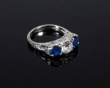 EDWARDIAN PERIOD DIAMOND AND SAPPHIRE RING: Centrally set Round Brilliant cut Diamond. 0.67ct (by calculation). Clarity SI-2, Color J. Side natural Sapphires are vivid blue. Stamped Platinum. Size 4 1/2. 2.65dwt. Good condition. 2.65dwt.