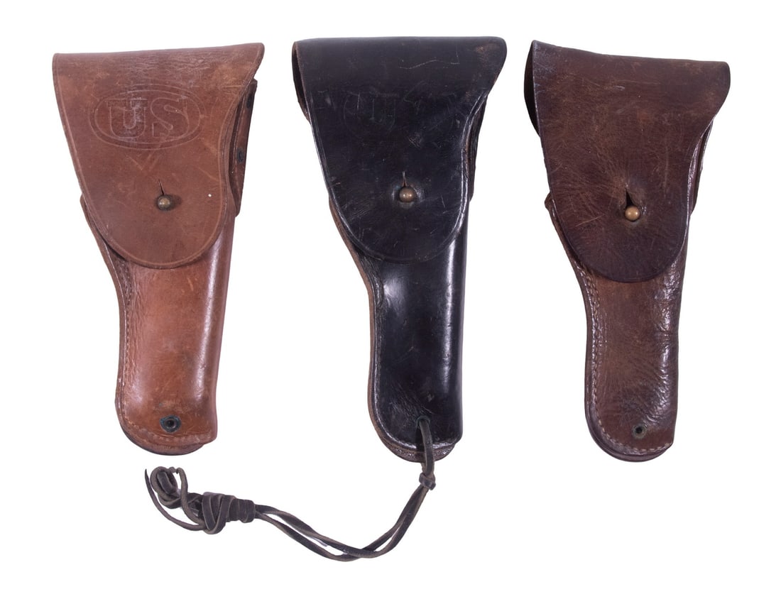 (3) US ARMY M1916 HOLSTERS: A set of three US Army issued holsters for the Colt 1911 from different manufacturers and periods. The earliest is made by the Warren Leather Goods Co. in a dark brown leather, likely having been manu