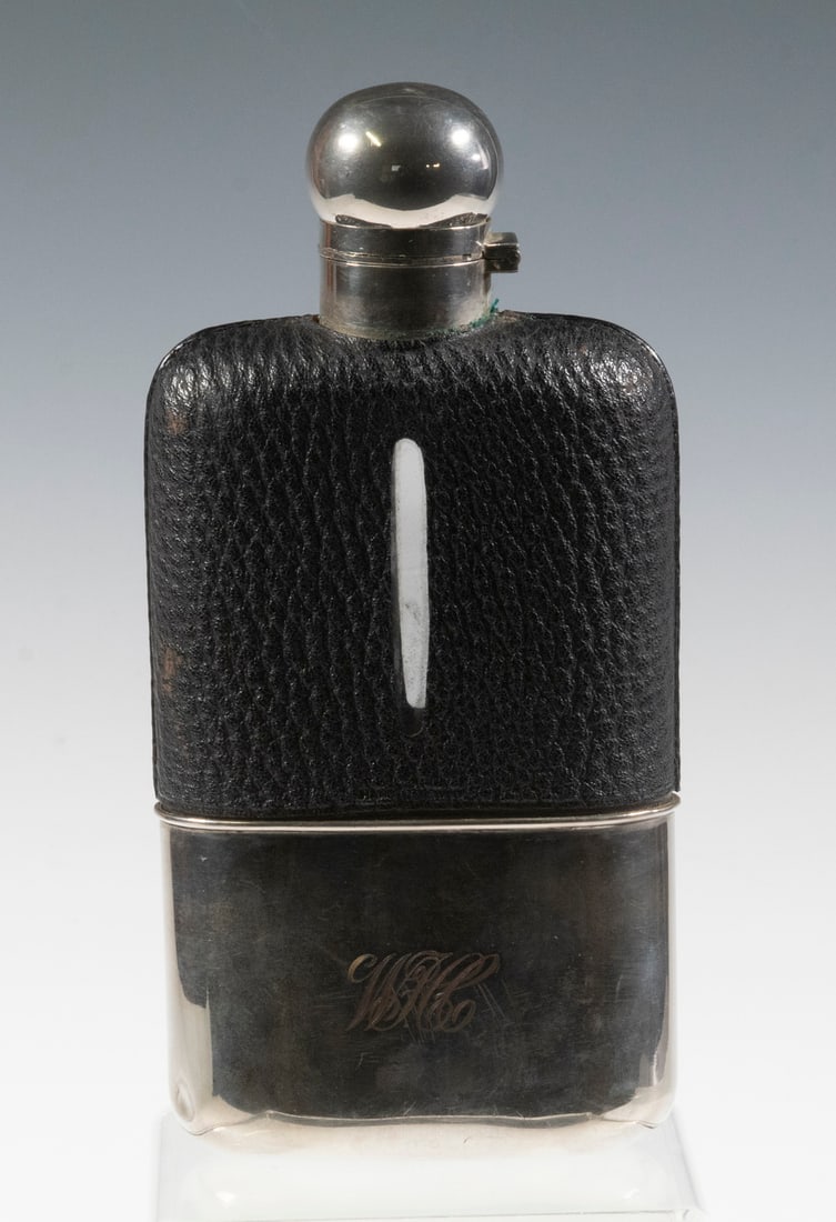 CA 1910 POCKET FLASK: Leather, glass, sterling silver and gilt silver lining, with "WFCC" script monogram, hinged lid. 8" tall. No maker's mark.