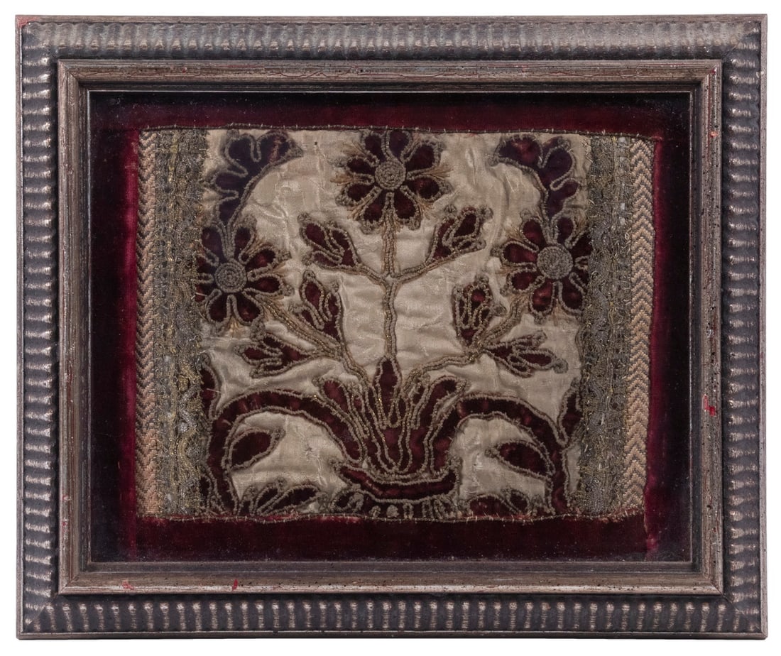 FRAGMENT OF RENAISSANCE CLOTH, FRAMED: Rich Fragment in crimson and cream silk velvet, with bullion and silver borders, in reverse ogee ribbed silver frame, under glass, 10" x 12".