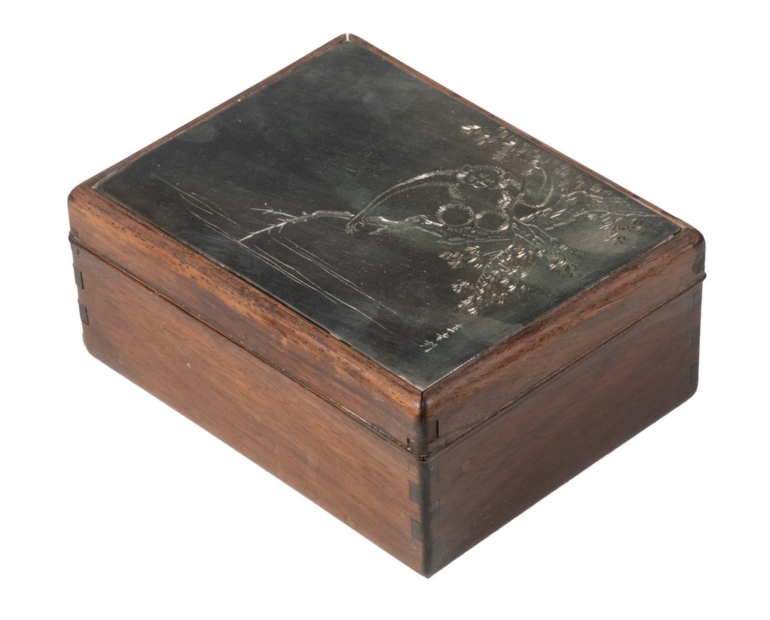 JAPANESE TEAK BOX WITH SILVER INSET LID: Vintage Rectangular Wooden Box, with exposed dovetails, with engraved silver lid plaque depicting a monkey hanging from a branch, artist signed by Naoko, 2 1/2" high, 5 1/4" x 4". Surface wear.