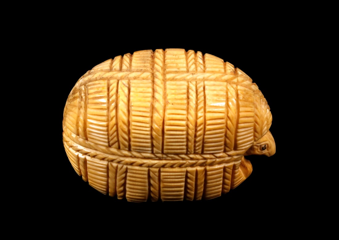 19TH C. JAPANESE IVORY NETSUKE: A Bundle of Rice with a Rat's Head protruding from one end while his tail droops from the other, unsigned, 1 3/4" wide, good condition.