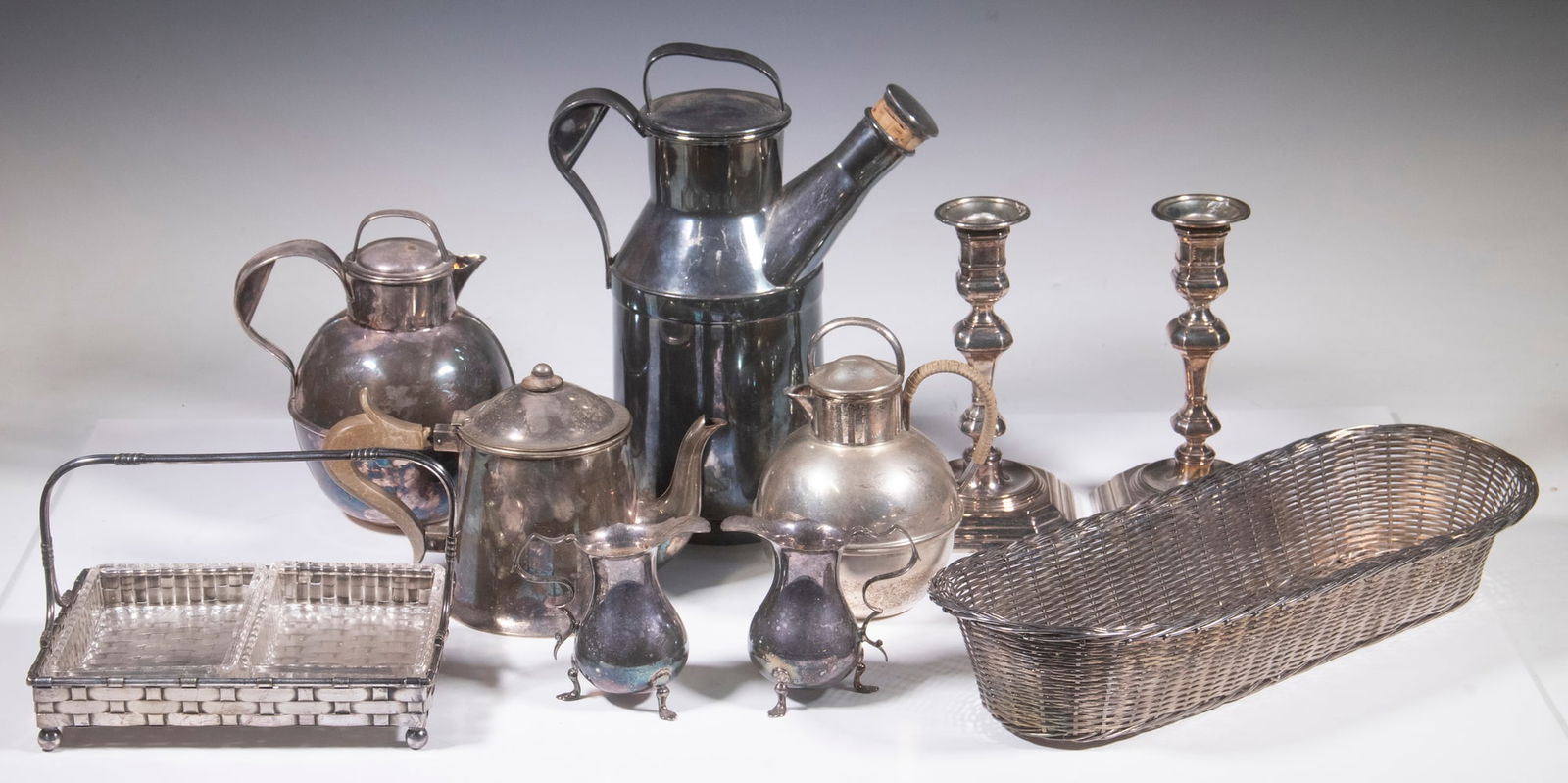 SILVER-PLATE SERVING ITEMS: (10) Piece Lot, incl: Reed & Barton Art Deco cocktail shaker/carafe, 64 oz, #25, 10 1/2" high, top handle dent; Pair of weighted Queen Anne style candlesticks, square bases, removable bobeches, 7" hig