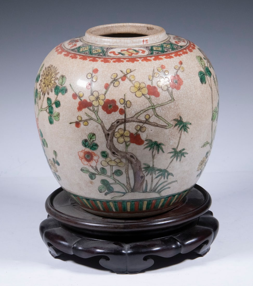 CHINESE GINGER JAR: Qing Dynasty Crackle Glaze Jar, with painted floral decoration, iron red painted four-character Guangxu (1874-1908) mark on base, with wooden stand, 8 1/2" high, 8 1/4" diam. Minor paint losses.