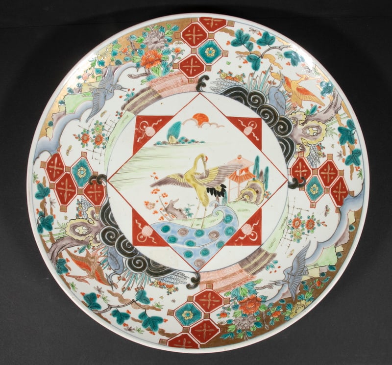 JAPANESE IMARI CHARGER: Japanese Porcelain Charger, central panel with standing spread wing crane, surrounded by decoration of cranes, trees, flowers and mons, 18 1/4" diam. Good condition.