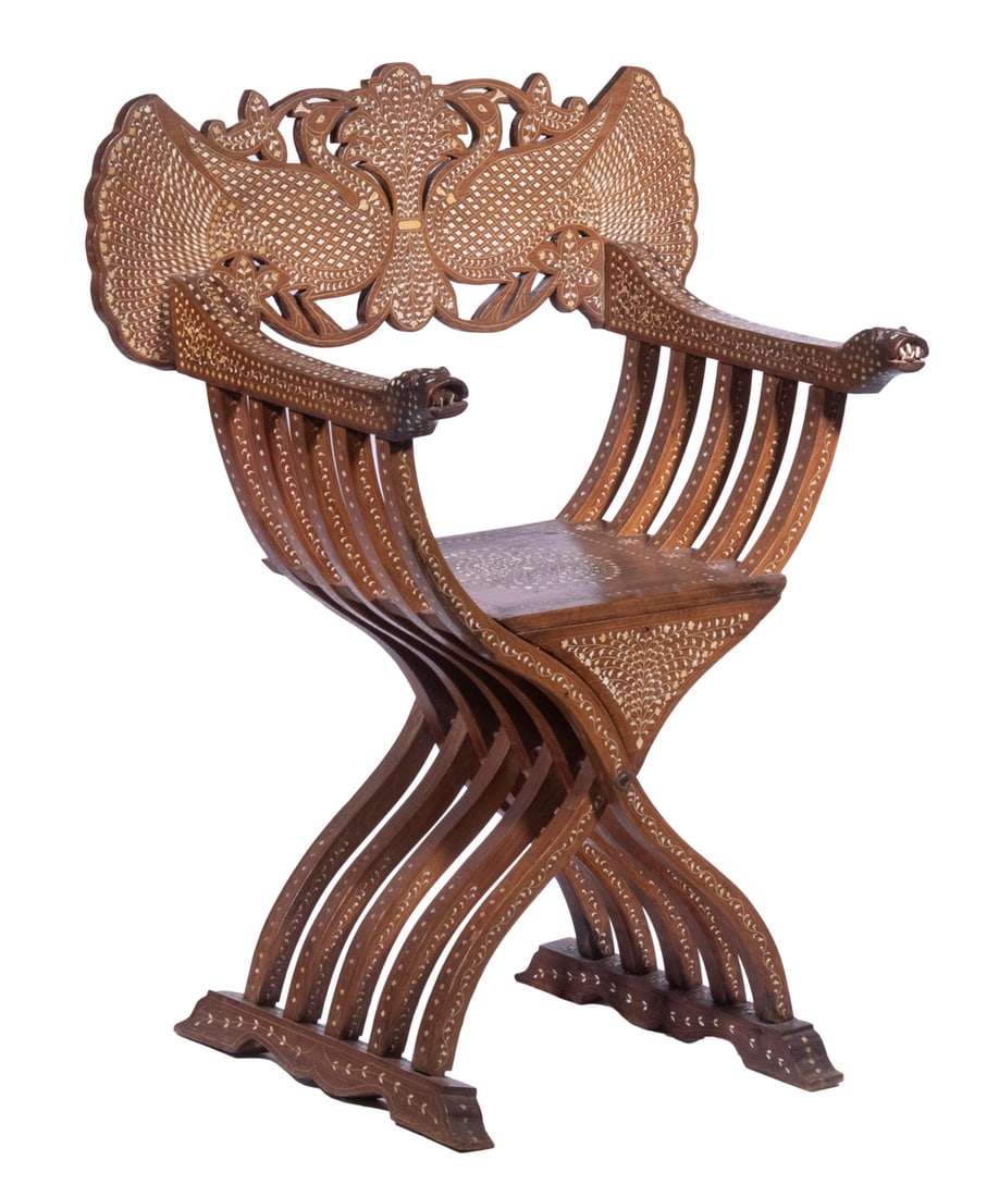 INLAID SAVONAROLA CHAIR: Late 19th c. Savonarola X-Frame Teak Folding Chair, with intricate bone and ebony inlaid decoration, having a pierced back in the form of opposing peacocks, leopard head arm terminals, 39 1/2" high, 2