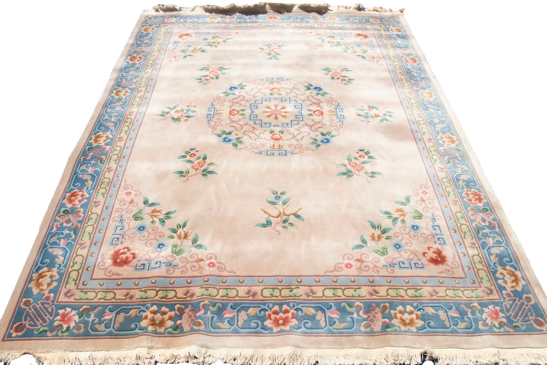 CHINESE CARPET (9' X 12'): Large rosette medallion with matching spandrels in navy and sky blue, lavender, ivory, and rust on the taupe field, with a pale blue vine and palmette border. Overall good condition.