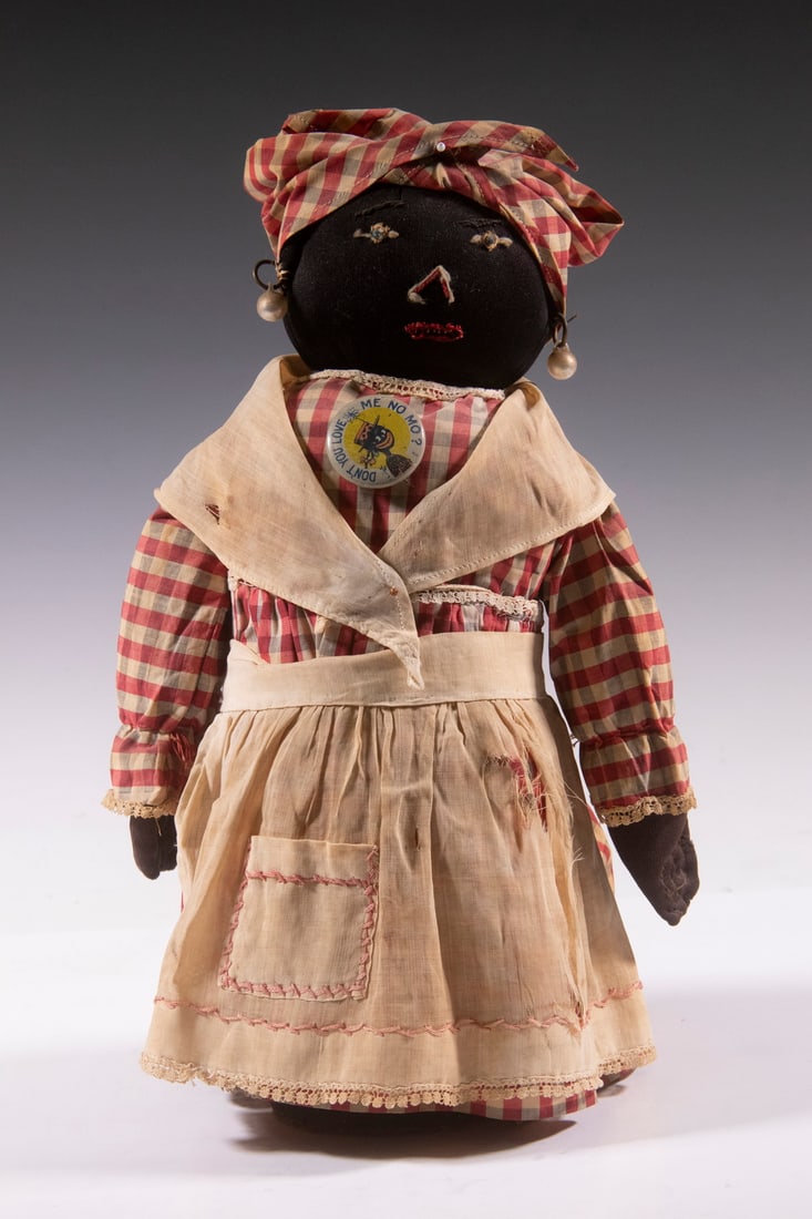 AMERICAN FOLK ART BLACKIANA FIGURE: Early 20th c. Standing 'Mammy" Figure, weighted, so probably a doorstop, having homemade cotton clothing of red checked calico dress and turban, apron with needlework, 'pearl' earrings, needlework fac