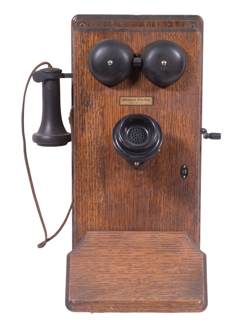 WESTERN ELECTRIC OAK CASED WALL TELEPHONE: Early 20th c. Crank Operated Wall Phone, with dovetailed oak case, tilting mouthpiece, working bells, original wiring, maker's decal affixed to front, 1913 dated wiring diagram affixed to door interio