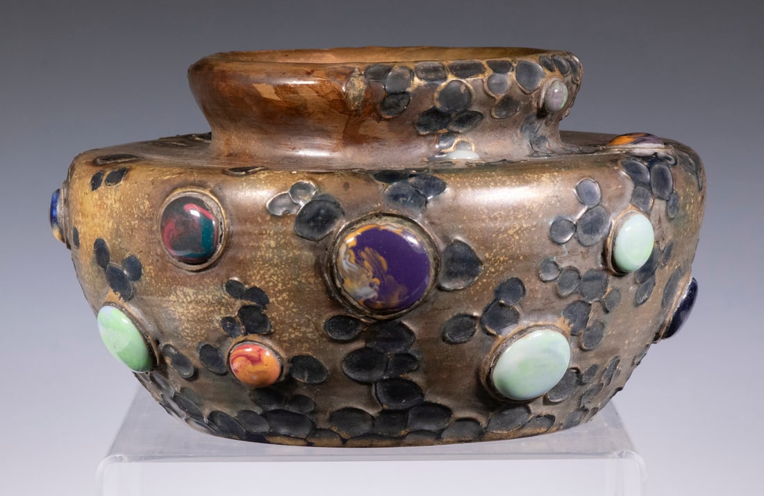 AMPHORA GRES-BIJOU JEWELED POTTERY VASE: Early 20th c. Austrian Art Nouveau Pottery Vase by Riessner & Kessel, squatty bulbous form with relief molded naturalistic design set with polished cabochon jewels, base with impressed Amphora crown m