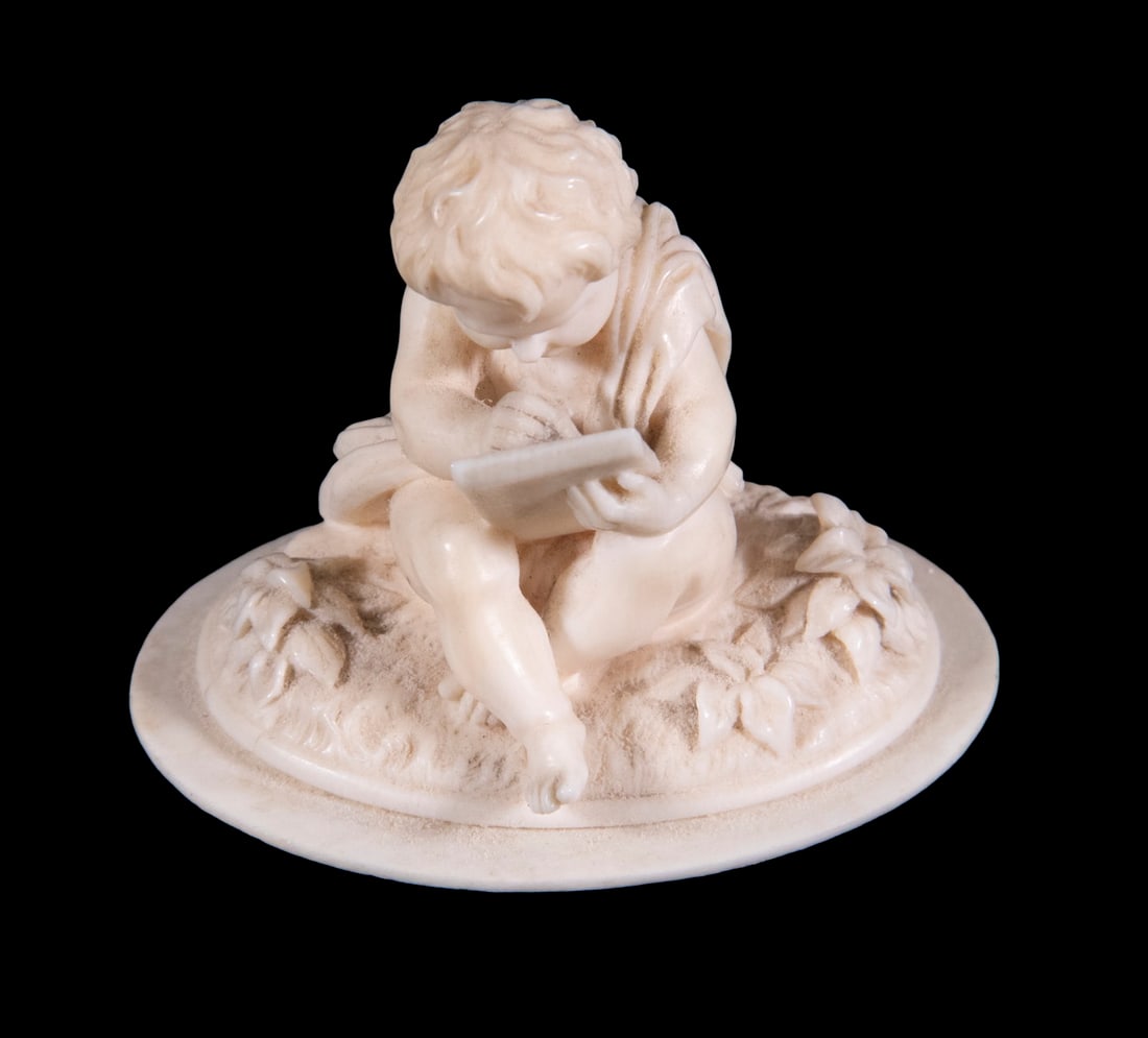 19TH C. MINIATURE IVORY SCULPTURE: Classical boy seated with a writing tablet, 19th c., 2" tall.