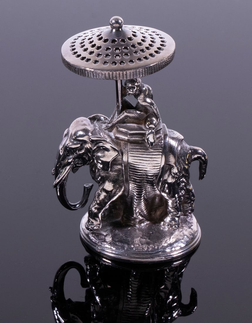 CHRISTOFLE SILVER-PLATE FIGURAL TOOTHPICK HOLDER: Charming French Table Accessory, by Christofle, in the form of a monkey atop an elephant holding a parasol, base stamped with Christofle marks, 3 3/4" high, 3 1/2" x 2".