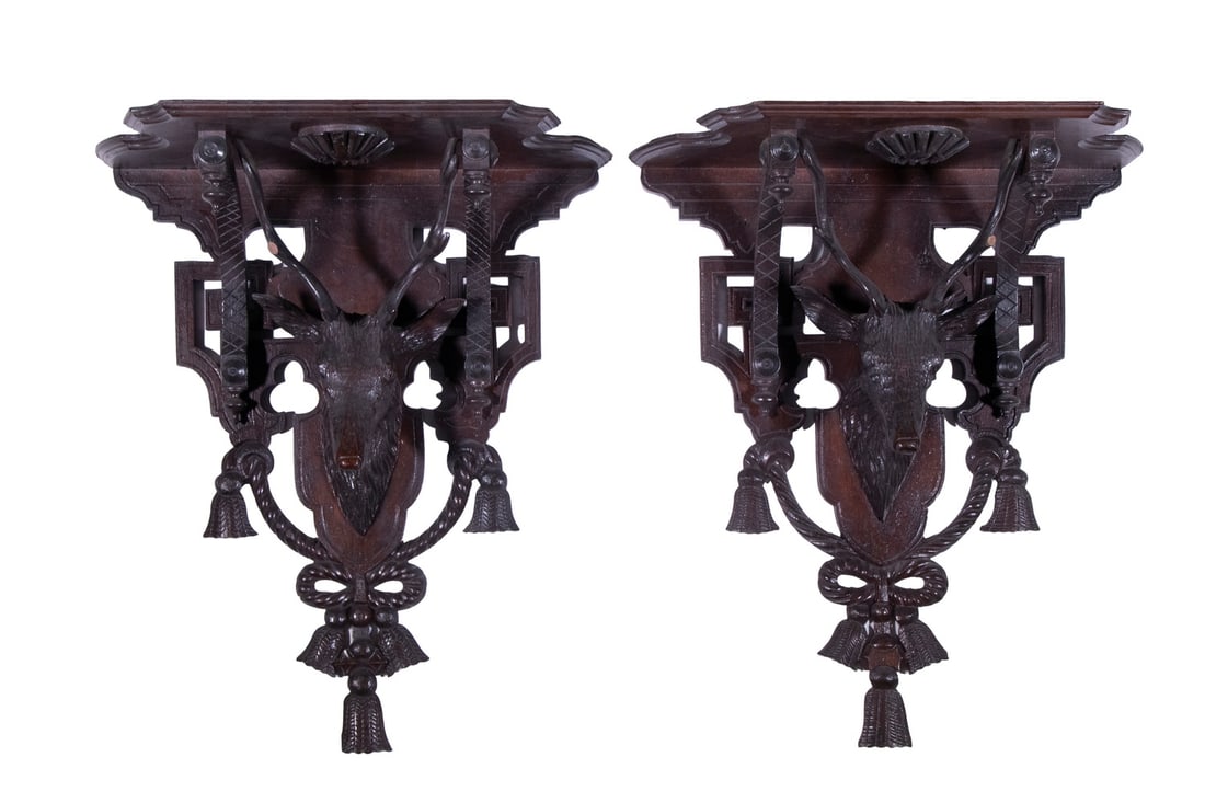 PR BLACK FOREST CARVED STAG HEAD WALL SHELVES: Pair of Ca. 1880 Walnut Wall Brackets, centered with deer heads, surrounded by carved swags, tassels, and Eastlake design embellishments, 18 1/2" high, 16" x 8". Two antler tip losses.