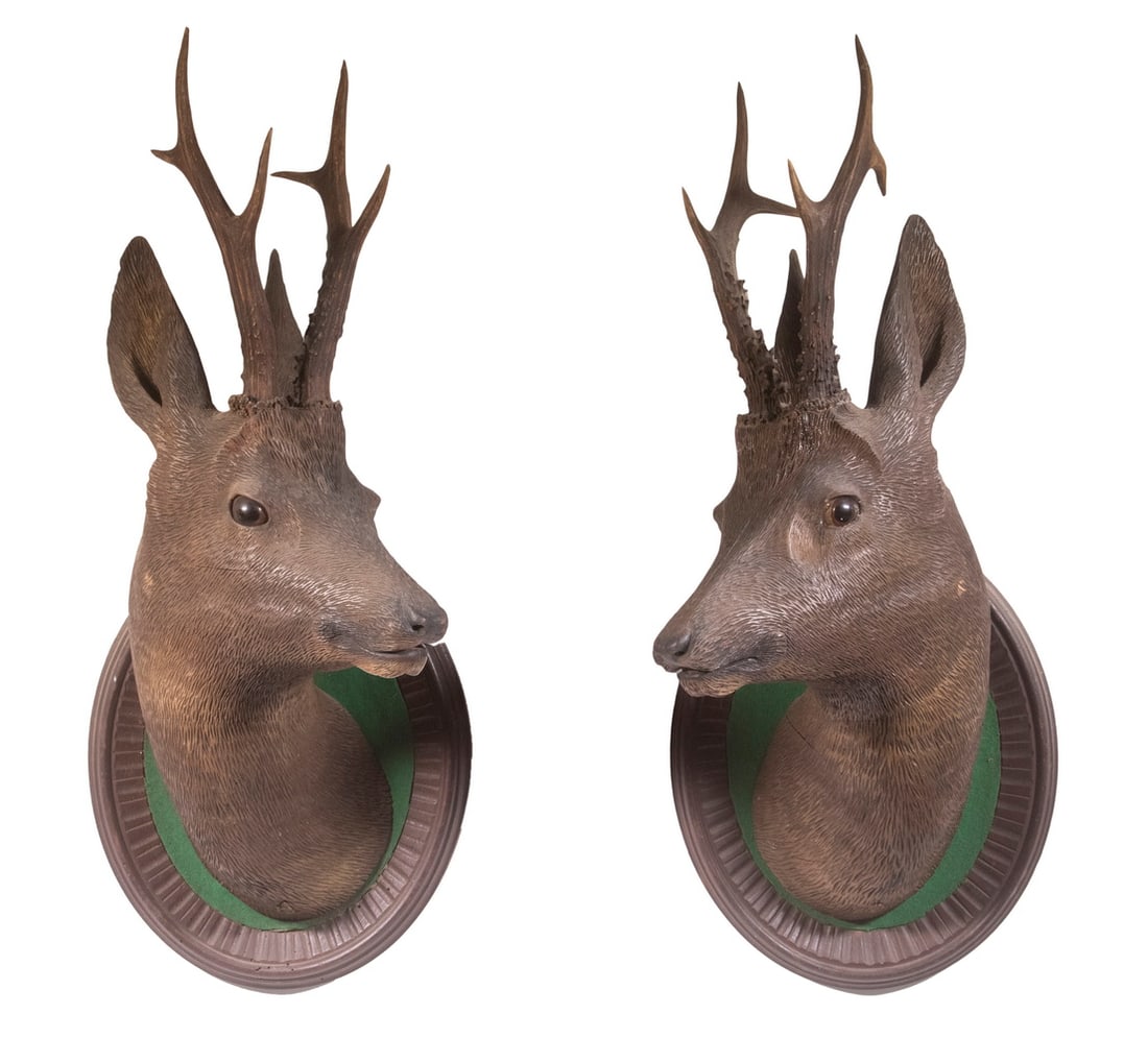 PR BLACK FOREST DEER HEADS: Matched Pair of Carved Wooden Deer Head Mounts, with glass eyes, partially open mouths with teeth, mounted on oval panels, 22 1/2" high, 9" wide.