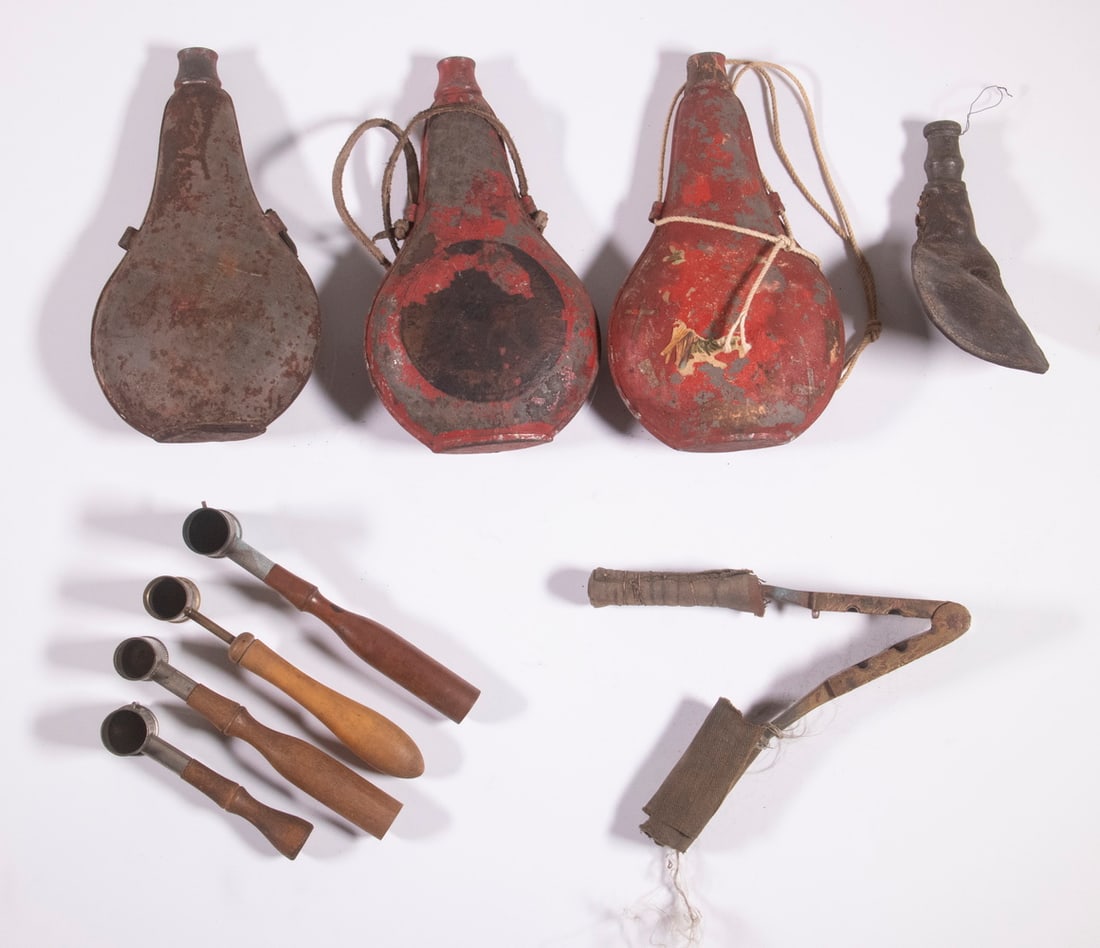 VINTAGE RELOADING EQUIPMENT: A collection of various pieces of reloading equipment to include three (3) metal powder flasks, four (4) adjustable powder scoops, a leather shot pouch, and a brass bullet mold with cloth heat wraps.