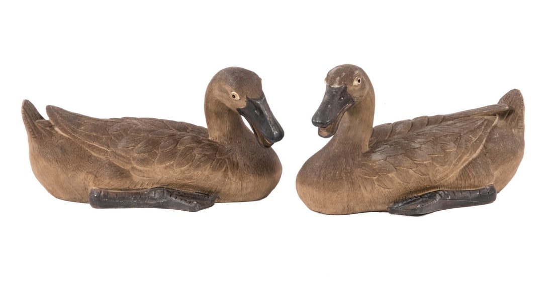 PR JAPANESE BANCO WARE DUCK FIGURINES: Pair of Meiji Period Stoneware Pottery Recumbent Ducks, with intricately detailed feathers, stamped seal mark on bases, 5" high, 8 1/4" x 5 1/4". Minor surface discoloration.