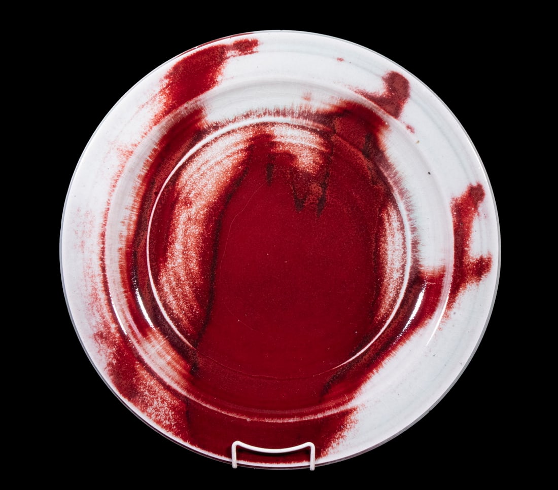 BROTHER THOMAS BEZANSON (CANADA/VT, 1929-2007): Large Round Porcelain Plate, in copper red over celadon glaze, ca. 1970s, signed on base with artist's cipher and "Benedictine Monks", Weston, Vermont", crafted while Brother Thomas was a member of th