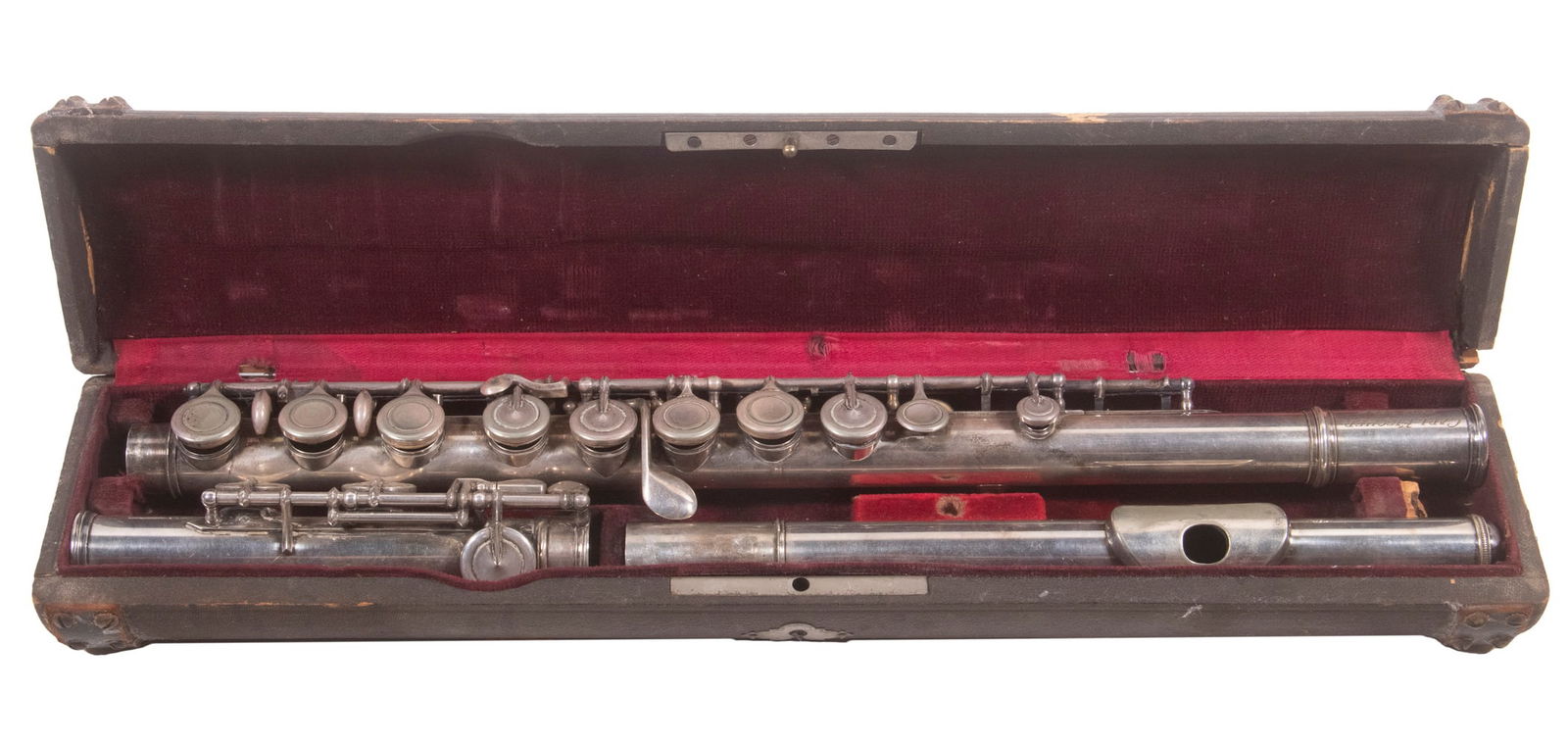 CIVIL WAR ERA SILVER FLUTE IN ORIGINAL CASE: Marked "Carl Fischer, New York", Bb, 27" long, good pads, 15" long wooden case with studded leather bands, wine velvet interior. Flute is very good, case is rough.