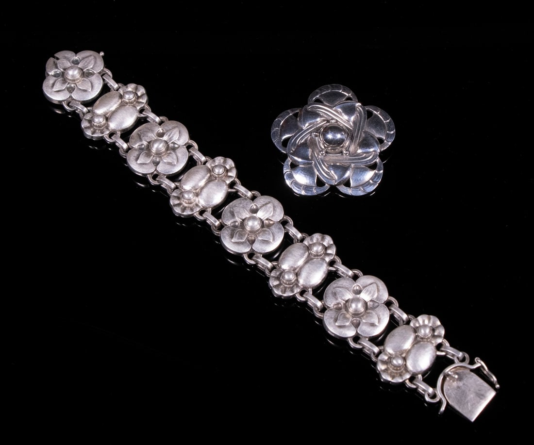 GEORG JENSEN STERLING BRACELET AND BROOCH: (2) Pieces of Mid-20th c. Danish Silver Jewelry, incl: Floral design link bracelet, #27, 1" wide, 7 1/4" long; and Floral star design brooch, #12, 1 3/4" diam.; 2.07 ozt tw.